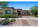 Single-story home with brick facade, landscaped yard, and a two-car garage at 10315 E Palladium Dr, Mesa, AZ 85212