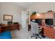 Spacious home office with wood desk and two computer monitors at 10315 E Palladium Dr, Mesa, AZ 85212