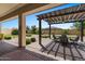 Covered patio with pergola, seating area, and lush landscaping at 10315 E Palladium Dr, Mesa, AZ 85212