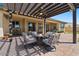 Pergola-covered patio with fire pit and comfortable seating at 10315 E Palladium Dr, Mesa, AZ 85212