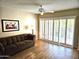 Living room with hardwood floors and sliding glass doors at 10330 W Thunderbird Blvd # A204, Sun City, AZ 85351