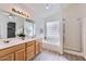 Elegant bathroom with double vanity and soaking tub at 11019 W Ventana W Dr, Sun City, AZ 85373