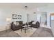 Relaxing living room featuring a brown sofa and glass coffee table at 11019 W Ventana W Dr, Sun City, AZ 85373