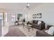 Bright living room featuring a comfy sofa and large windows at 11019 W Ventana W Dr, Sun City, AZ 85373