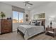 Cozy bedroom with wood dresser and neutral bedding at 1115 E Gleneagle St, Chandler, AZ 85249