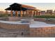 Relaxing firepit area with stone seating and pavilion at 1115 E Gleneagle St, Chandler, AZ 85249