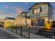 Two-story home with modern facade, two-car garage and a fenced yard at 1115 E Gleneagle St, Chandler, AZ 85249