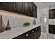 Bright laundry room with dark cabinetry and built-in storage at 1115 E Gleneagle St, Chandler, AZ 85249