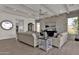 Bright living room with hardwood floors, beige sofa and large window at 1115 E Gleneagle St, Chandler, AZ 85249