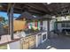 Outdoor kitchen with built-in grill, refrigerator, and covered patio at 1125 E Northview Ave, Phoenix, AZ 85020