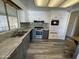 Renovated kitchen, featuring stainless steel appliances and gray cabinets at 11411 N 91St Ave # 221, Peoria, AZ 85345