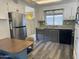 Bright kitchen with stainless steel appliances and wood-look flooring at 11411 N 91St Ave # 221, Peoria, AZ 85345