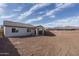 Backyard showing dirt and a covered patio area, ready for customization at 12766 W Parkway Ln, Avondale, AZ 85323