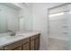 Bathroom with a single vanity, quartz countertops, and a separate tub and shower at 12766 W Parkway Ln, Avondale, AZ 85323