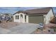 Exterior of single Gathering home with an attached two-car garage and covered entry at 12766 W Parkway Ln, Avondale, AZ 85323