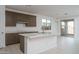 Bright kitchen featuring modern appliances, a center island with a sink, and plenty of counter space at 12766 W Parkway Ln, Avondale, AZ 85323