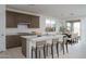 Modern kitchen featuring a center island with seating, stainless appliances, and natural light at 12766 W Parkway Ln, Avondale, AZ 85323