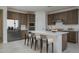 Modern kitchen featuring stainless steel appliances, a center island with seating, and ample cabinet space at 12766 W Parkway Ln, Avondale, AZ 85323