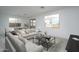 Comfortable living room featuring a modern sofa, stylish coffee table, and an open layout at 12766 W Parkway Ln, Avondale, AZ 85323