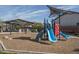 Community playground with a slide, swings, covered picnic tables and shade at 12766 W Parkway Ln, Avondale, AZ 85323