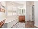 Spa-like bathroom with a soaking tub and double vanity at 1301 E Ibis St, Gilbert, AZ 85297