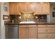 Kitchen with light wood cabinets, granite countertops, and a double sink at 13606 N 108Th Dr, Sun City, AZ 85351