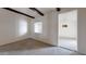 Carpeted bedroom with wood beams and window at 143 N 88Th Pl, Mesa, AZ 85207