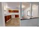 Kitchen with wood cabinets, white appliances, and view to hallway at 143 N 88Th Pl, Mesa, AZ 85207