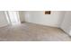 Carpeted living room featuring a patio door and window at 143 N 88Th Pl, Mesa, AZ 85207