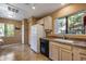 Galley kitchen with white appliances and light wood cabinets at 15050 N Thompson Peak Pkwy # 1059, Scottsdale, AZ 85260