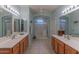 Double vanity bathroom with large shower and tile flooring at 16169 W Fairmount Ave, Goodyear, AZ 85395