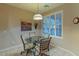 Bright breakfast nook with glass table and four chairs at 16169 W Fairmount Ave, Goodyear, AZ 85395