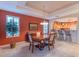 Formal dining room with a large table and views into the kitchen at 16169 W Fairmount Ave, Goodyear, AZ 85395