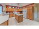 Spacious kitchen with light wood cabinets and an island at 16169 W Fairmount Ave, Goodyear, AZ 85395