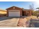 Single-story house with attached garage and desert landscaping at 16173 W Monroe St, Goodyear, AZ 85338