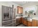 Stainless steel appliances and a farmhouse sink highlight this kitchen at 16173 W Monroe St, Goodyear, AZ 85338