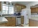 Galley kitchen with stainless steel appliances and light wood cabinets at 17200 W Bell Rd # 2255, Surprise, AZ 85374