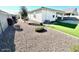 Backyard with gravel, artificial turf and shrubs at 18352 W Chama Dr, Wittmann, AZ 85361