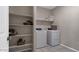 Bright laundry room with washer, dryer and shelving at 18352 W Chama Dr, Wittmann, AZ 85361