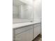 White bathroom vanity with a marble countertop and double drawers at 18363 W Smoketree Dr, Wittmann, AZ 85361