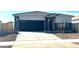 One-story home with dark gray garage door and stone accents at 18363 W Smoketree Dr, Wittmann, AZ 85361