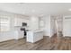 Open concept kitchen with island, white cabinets, and stainless steel appliances at 18363 W Smoketree Dr, Wittmann, AZ 85361