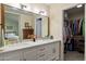 Bathroom with double vanity, large mirror, and walk-in closet at 1920 E Maryland Ave # 21, Phoenix, AZ 85016