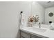 Bathroom with gray vanity, quartz countertop, and a decorative flower arrangement at 1920 E Maryland Ave # 21, Phoenix, AZ 85016