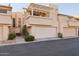 Tan two-story townhome with a pergola-covered balcony and attached garage at 1920 E Maryland Ave # 21, Phoenix, AZ 85016