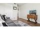 Living room with gray sofa and wooden cabinet at 1920 E Maryland Ave # 21, Phoenix, AZ 85016