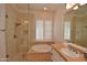 Bathroom with walk-in shower, soaking tub, and double vanity at 20704 N 90Th Pl # 1008, Scottsdale, AZ 85255