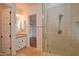 Bathroom with walk-in shower, single vanity, and view of bedroom at 20704 N 90Th Pl # 1008, Scottsdale, AZ 85255