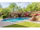 Community pool and spa with lounge chairs and covered patio at 20704 N 90Th Pl # 1008, Scottsdale, AZ 85255