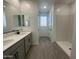 Bathroom featuring double sinks, gray cabinets, and a walk-in shower at 22852 E Lords Way, Queen Creek, AZ 85142